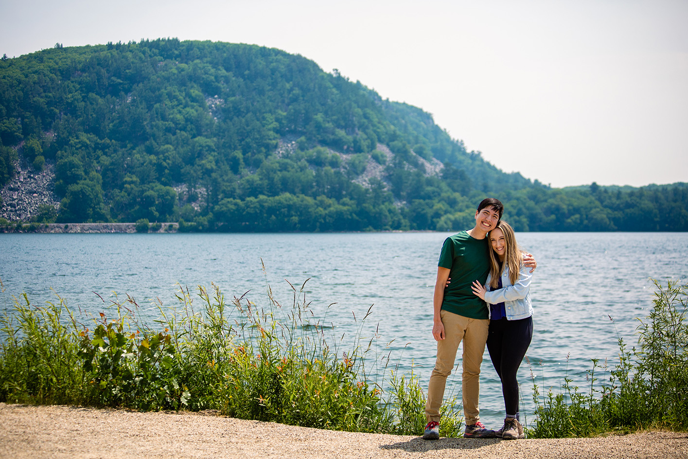 Gary and Natalie standing together in front of a lake.
